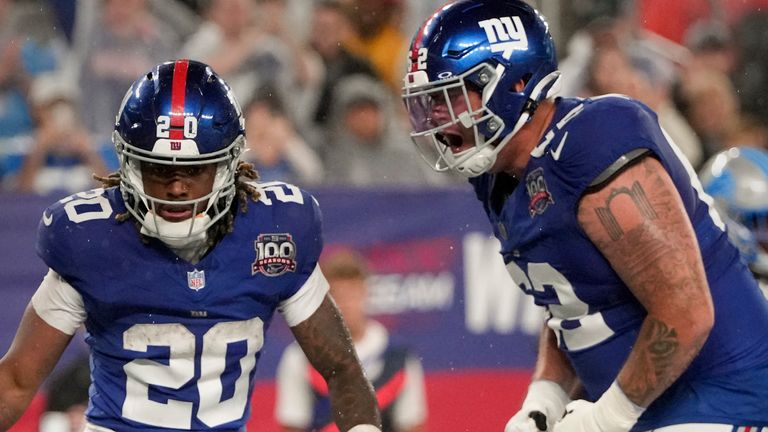 New York Giants running back Eric Gray (20) celebrates with New York Giants guard Jalen Mayfield (62) after scoring a touchdown against the Detroit Lions in the second quarter of an NFL football game, Thursday, Aug. 8, 2024, in East Rutherford, N.J. (AP Photo/Pamela Smith)