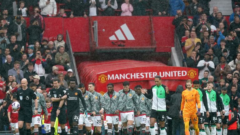 Manchester United and Liverpool players walk onto the pitch before the Premier League match at Old Trafford, Manchester. Picture date: Sunday April 7, 2024.