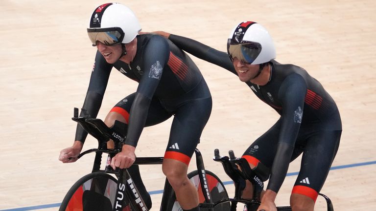 Britain's' Ethan Vernon, and Oliver Wood, left, congratulate each other after competing in the men's team pursuit event, at the Summer Olympics, Tuesday, Aug. 6, 2024, in Paris, France. (AP Photo/Thibault Camus)