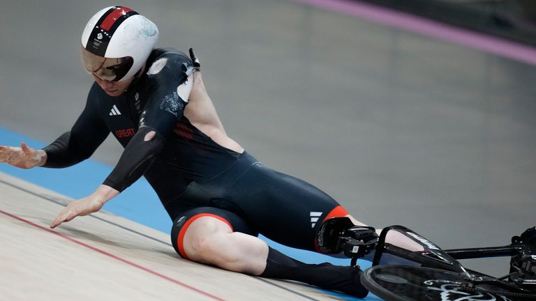 Jack Carlin of Britain crashes during the men's keirin event, at the Summer Olympics, Sunday, Aug. 11, 2024, in Paris, France. (AP Photo/Ricardo Mazalan)