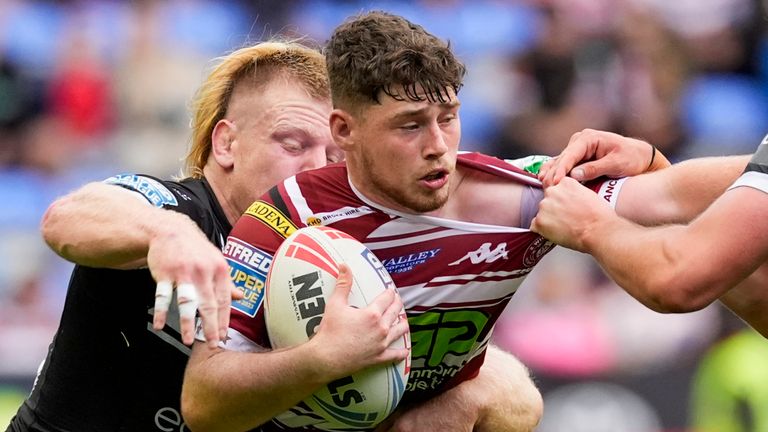 Picture by Olly Hassell/SWpix.com - 25/08/2024 - Rugby League - Betfred Super League Round 23 - Wigan Warriors v Hull FC - the Brick Community Stadium, Wigan, England - Jack Farrimond of Wigan is tackled by Will Gardiner of Hull FC