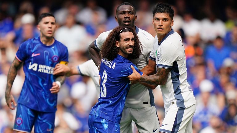 Marc Cucurella grapples in the penalty area with Inter players