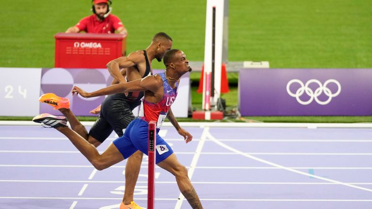 Quincy Hall, of the United States, crosses the finish line followed by Matthew Hudson-Smith, of Britain, in the men's 400-meters final at the 2024 Summer Olympics, Wednesday, Aug. 7, 2024, in Saint-Denis, France. (AP Photo/Natacha Pisarenko)