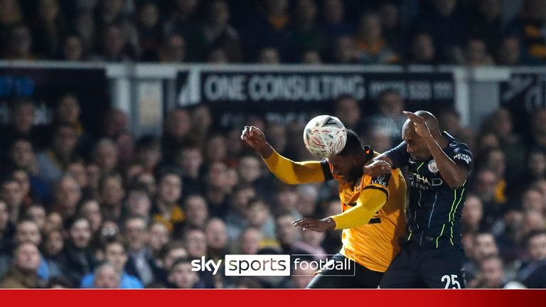 Newport County's Jamille Matt, left, heads the ball past Manchester City's Fernandinho during the English FA Cup fifth round soccer match between Newport County and Manchester City 