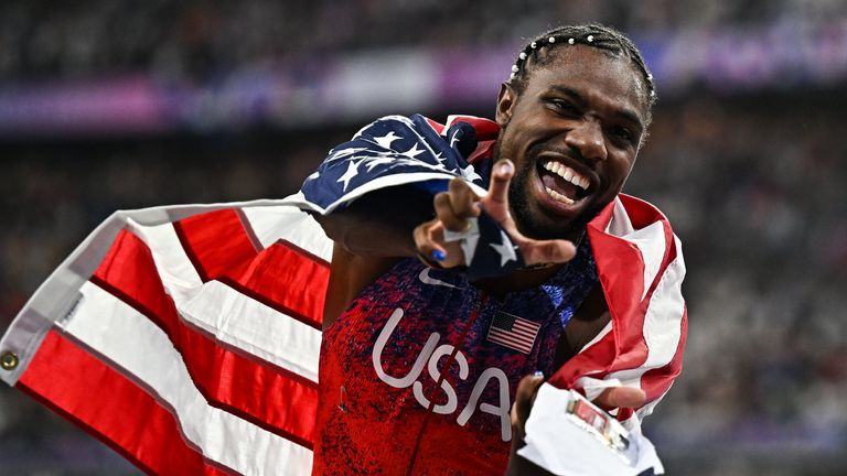 Noah Lyles celebrates winning the men's 100m final at the Stade de France 