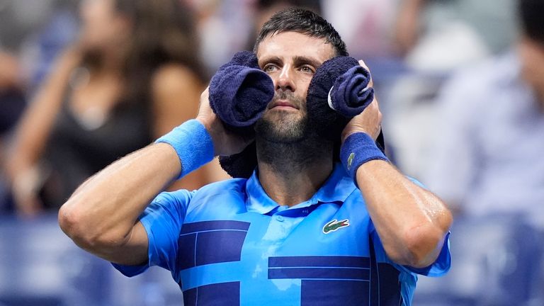 Novak Djokovic, of Serbia, puts a towel around his neck nduring a second round match against Laslo Djere, of Serbia, of the U.S. Open tennis championships, Wednesday, Aug. 28, 2024, in New York. (AP Photo/Frank Franklin II)