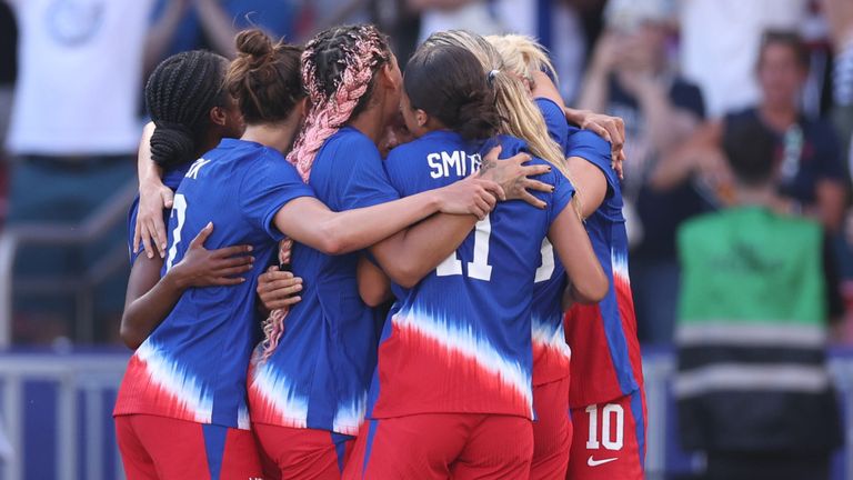 USA goalscorer Mallory Swanson is mobbed by her team-mates