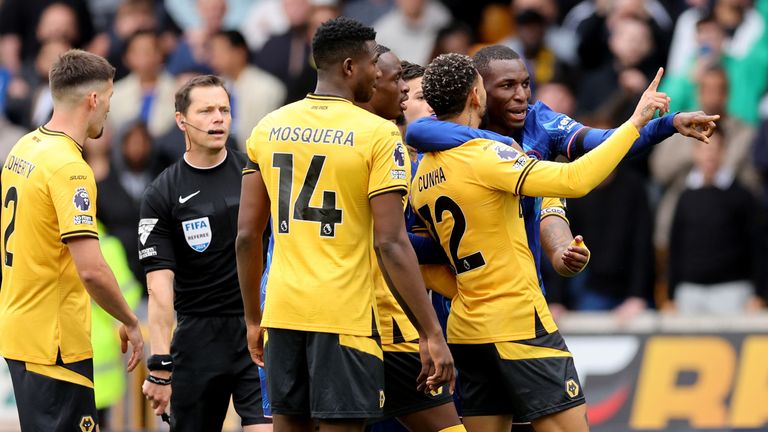 Nicolas Jackson speaks with Wolves' Matheus Cunha after scoring Chelsea's opening goal at Molineux