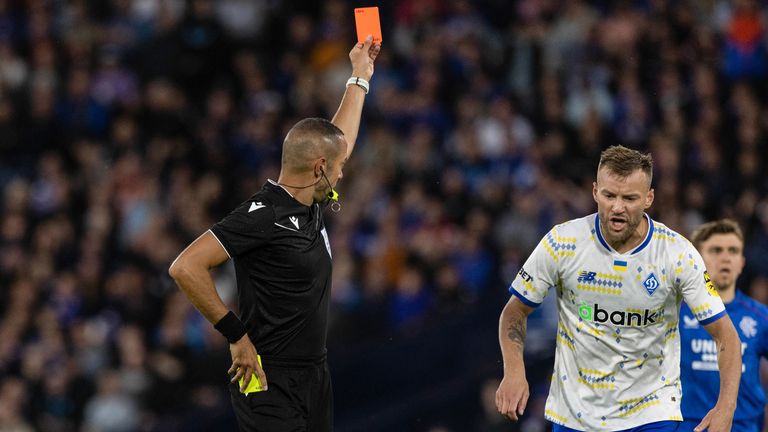 Referee Marco Guida shows Rangers player Jefte the red card 