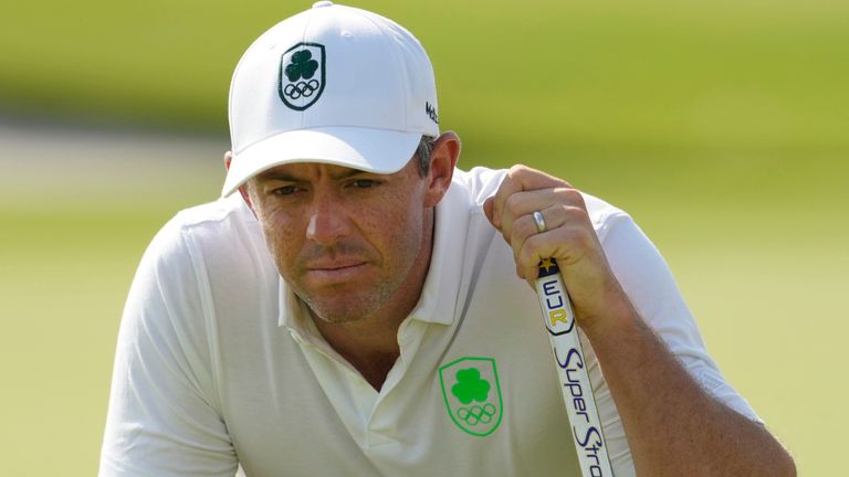 Rory McIlroy, of Ireland, looks at the lie of his putt on the 18th green during the second round of the men's golf event at the 2024 Summer Olympics, Friday, Aug. 2, 2024, at Le Golf National in Saint-Quentin-en-Yvelines, France. (AP Photo/Matt York)