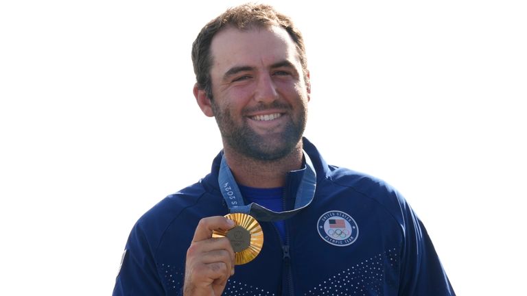 Gold medalist Scottie Scheffler, of the United States, poses with his medal following the medal ceremony for men's golf during the medal ceremony at the 2024 Summer Olympics, Sunday, Aug. 4, 2024, at Le Golf National in Saint-Quentin-en-Yvelines, France. Scottie Scheffler, of the United States, won the gold medal with Tommy Fleetwood, of Britain, silver and Hideki Matsuyama, of Japan, the bronze.(AP Photo/Matt York)