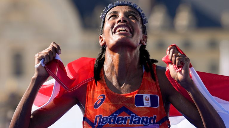 Sifan Hassan, of the Netherlands, celebrates after crossing the finish line to win the gold medal at the end of the women's marathon competition at the 2024 Summer Olympics, Sunday, Aug. 11, 2024, in Paris, France. (AP Photo/Vadim Ghirda)