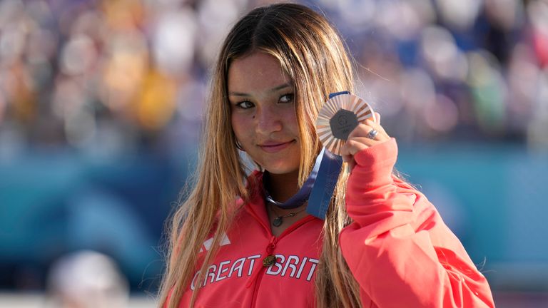 Olympic bronze medalist Skye Brown of Great Britain poses for a photo with her medal after the women's skateboard park final at the 2024 Summer Olympics, Tuesday, Aug. 6, 2024, in Paris, France. (AP Photo/Vadim Ghirda)