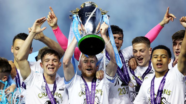 Tommy Doyle of Manchester City lifts the Premier League 2 trophy alongside his teammates following the Premier League 2 match between Manchester city and Tottenham Hotspur at Manchester City Football Academy on April 30, 2021 in Manchester, England.