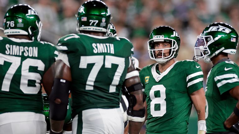 New York Jets quarterback Aaron Rodgers (8) with teammates during an NFL football game against the New England Patriots Thursday, Sept. 19, 2024, in East Rutherford, N.J. (AP Photo/Adam Hunger) 