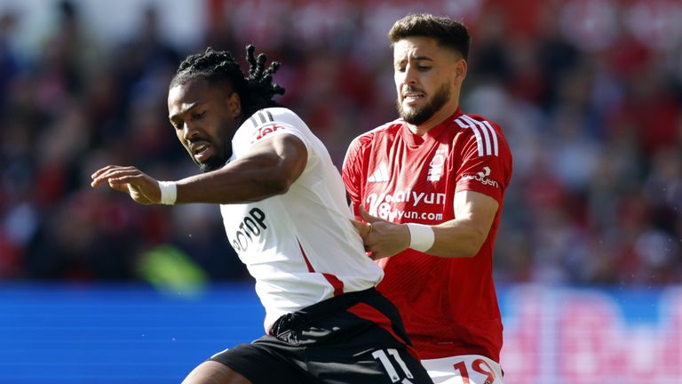 Fulham's Adama Traore and Nottingham Forest's Alex Moreno (right) battle for the ball 