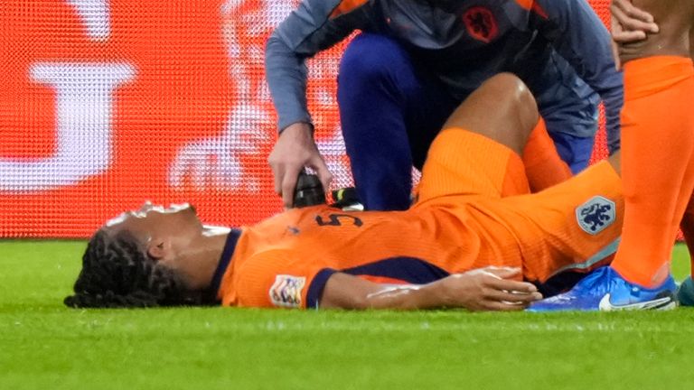 Nathan Ake of the Netherlands lies injured dured during the UEFA Nations League soccer match between Netherlands and Germany in Amsterdam, Netherlands, on Tuesday, Sept. 10, 2024. (AP Photo/Peter Dejong)