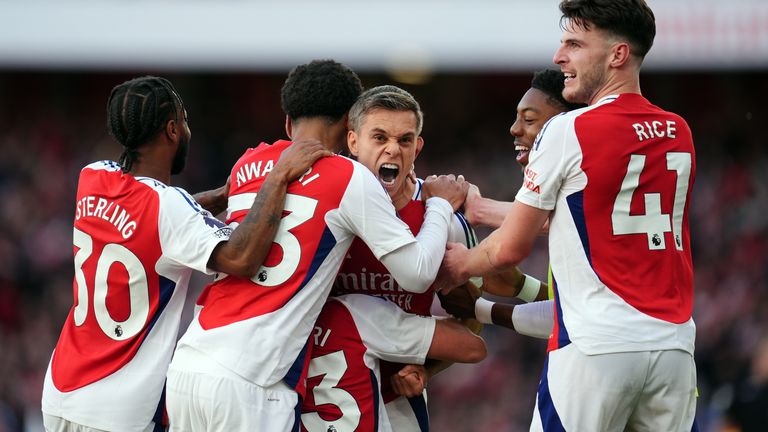 Arsenal players celebrate after Wilfried Nididi's own goal puts them back in front against Leicester