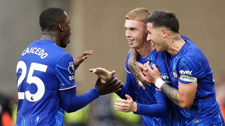 Chelsea's Cole Palmer (centre) celebrates scoring his sides second goal of the game with Moises Caicedo (left) and Enzo Fernandez during the Premier League match at Molineux Stadium, Wolverhampton. Picture date: Sunday August 25, 2024.