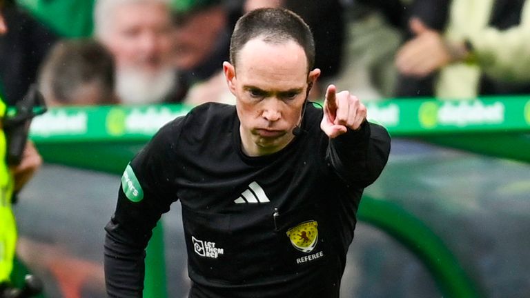 Following a VAR check referee Colin Steven signals for a penalty to Celtic after a handball by Hearts' James Penrice