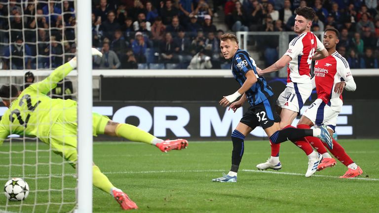 Arsenal's David Raya gets up to save Mateo Retegui's follow-up shot for Atalanta after the penalty