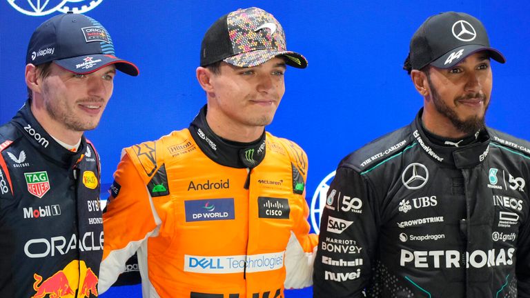 McLaren driver Lando Norris of Britain, centre, celebrates his pole position with second placed Red Bull driver Max Verstappen of the Netherlands, left, and third placed Mercedes driver Lewis Hamilton of Britain after qualifying session of the Singapore Formula One Grand Prix at the Marina Bay Street Circuit, in Singapore, Saturday, Sept. 21, 2024. (AP Photo/Vincent Thian)