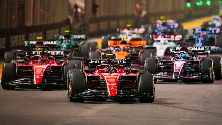 Ferrari driver Carlos Sainz of Spain leads the field into turn one at the start of the Singapore Formula One Grand Prix at the Marina Bay circuit, Singapore,Sunday, Sept. 17, 2023. (AP Photo/Vincent Thian)