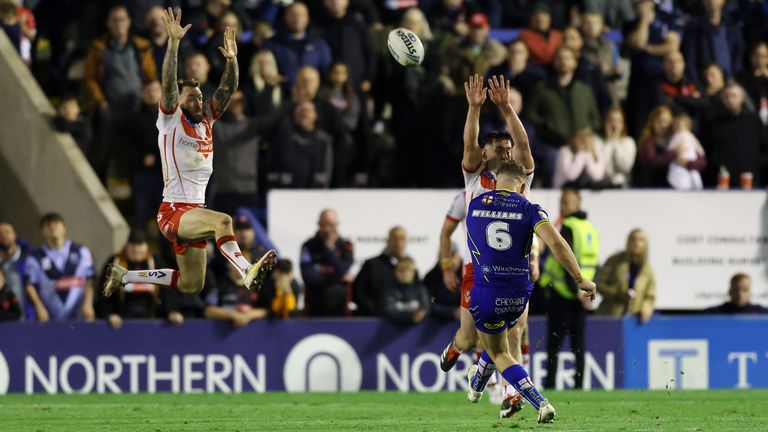 Warrington Wolves' George Williams scores a golden point drop-goal to win the Betfred Super League play-off eliminator match at The Halliwell Jones Stadium,
