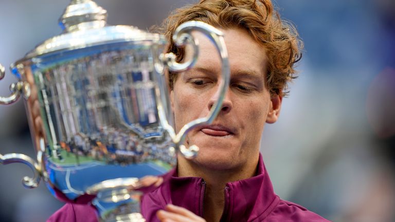 Jannik Sinner, of Italy, holds up the championship trophy after defeating Taylor Fritz, of the United States, in the men's singles final of the U.S. Open tennis championships, Sunday, Sept. 8, 2024, in New York. (AP Photo/Julia Nikhinson)