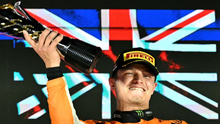 McLaren's British driver Lando Norris celebrates winning on the podium after the Formula One Singapore Grand Prix night race at the Marina Bay Street Circuit in Singapore on September 22, 2024. (Photo by MOHD RASFAN / AFP)