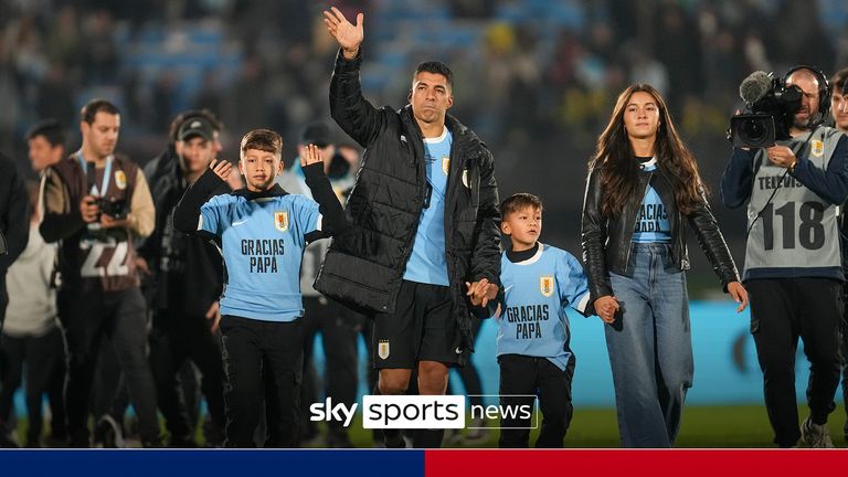 Uruguay's Luis Suarez waves to fans, accompanied by his children, after a qualifying soccer match for the FIFA World Cup 2026 against Paraguay, in Montevideo, Uruguay, Friday, Sept. 6, 2024. Suarez played his last game for Uruguay ending a 17 years international carrer. (AP Photo/Matilde Campodonico)