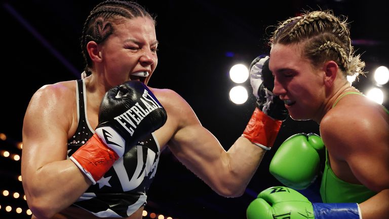 Mikaela Mayer (green trunks) trades punches with Sandy Ryan (black trunks) 