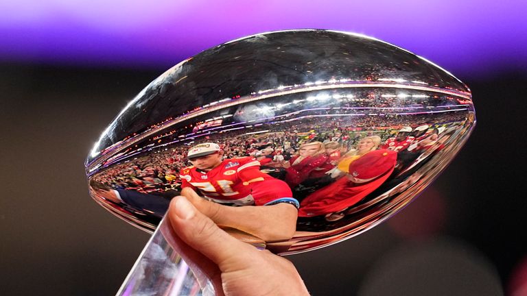 Kansas City Chiefs quarterback Patrick Mahomes is reflected in the Vince Lombardi Trophy after the 58th NFL Super Bowl football game against the San Francisco 49ers on Sunday, February 11, 2024, in Las Vegas.