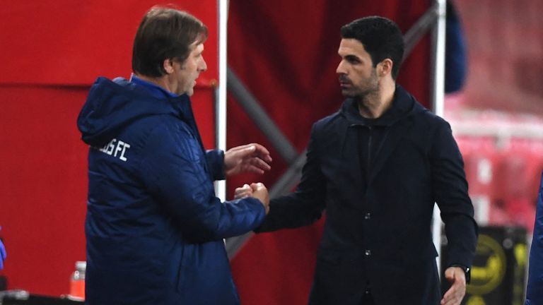 Olympiakos' Portuguese coach Pedro Martins (L) and Arsenal's Spanish manager Mikel Arteta react at the final whistle during the UEFA Europa League Round of 16, 2nd leg football match between Arsenal and Olympiakos at the Emirates Stadium in London on March 18, 2021.