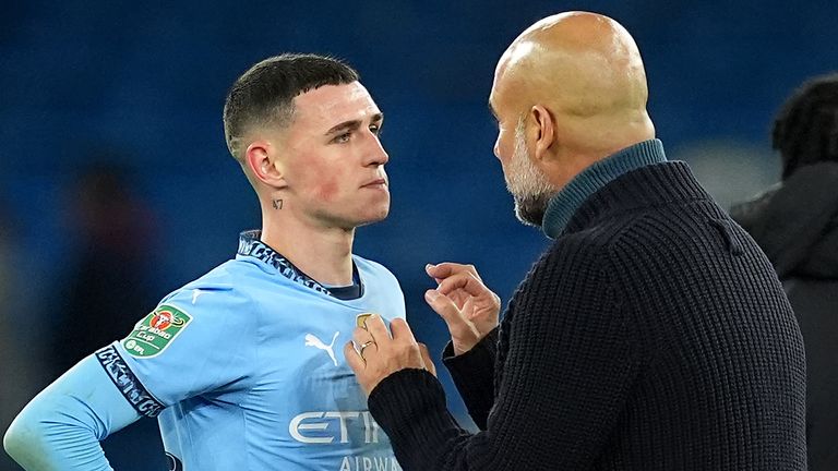 Phil Foden speaks to Pep Guardiola