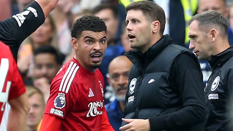 Fabian Huerzeler is shown a red card by referee Robert Jones as Morgan Gibs-White - also sent off by Jones - looks on