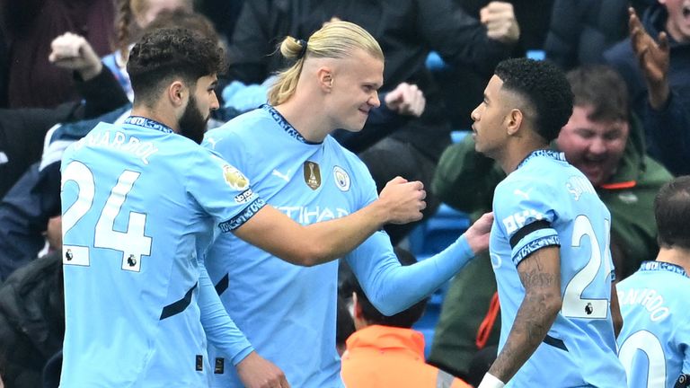 Erling Haaland celebrates with Savinho after scoring Man City's opening goal against Arsenal