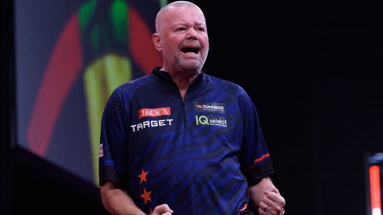 Raymond van Barneveld celebrates during his World Series of Darts opener in front of an adoring Amsterdam crowd