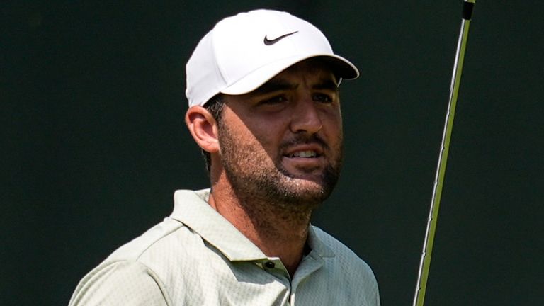 Scottie Scheffler watches his ball on the first fairway during the final round of the Tour Championship golf tournament, Sunday, Sept. 1, 2024, in Atlanta. (AP Photo/Mike Stewart)