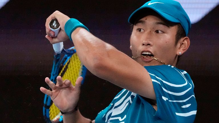 Shang Juncheng of China plays a forehand return to Frances Tiafoe of the U.S. during their second round match at the Australian Open tennis championship in Melbourne, Australia, Wednesday, Jan. 18, 2023. (AP Photo/Aaron Favila)