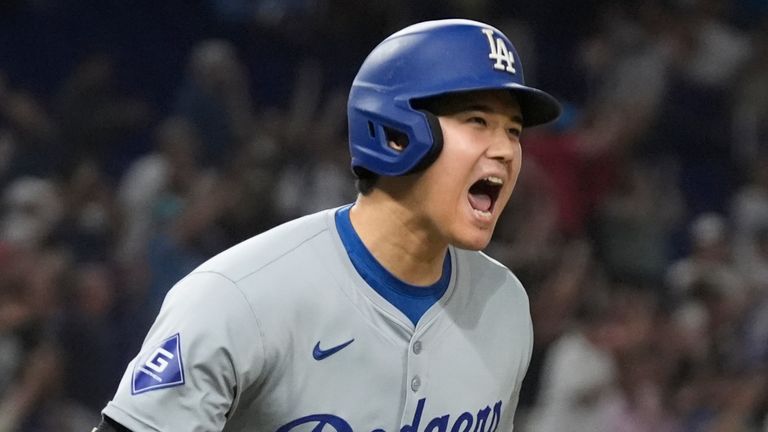 Los Angeles Dodgers' Shohei Ohtani (17) reacts after hitting his 50th home run of the season during the seventh inning of a baseball game against the Miami Marlins, Thursday, Sept. 19, 2024, in Miami. (AP Photo/Marta Lavandier)