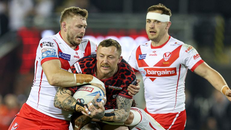 Picture by Paul Currie/SWpix.com - 20/09/2024 - Rugby League - Betfred Super League Round 27 - Leigh Leopards v St Helens - Leigh Sports Village, Leigh , England - Leigh Leopards' Josh Charnley is tackled by St Helens' Joe Batchelor