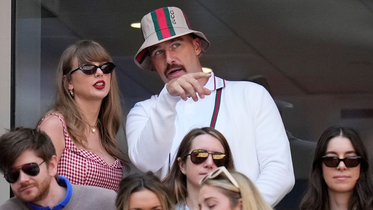 Taylor Swift, left, and Travis Kielce watch play between Jannik Sinner, of Italy, and Taylor Fritz, of the United States, during the men's singles final of the U.S. Open tennis championships, Sunday, Sept. 8, 2024, in New York. (AP Photo/Kirsty Wigglesworth)