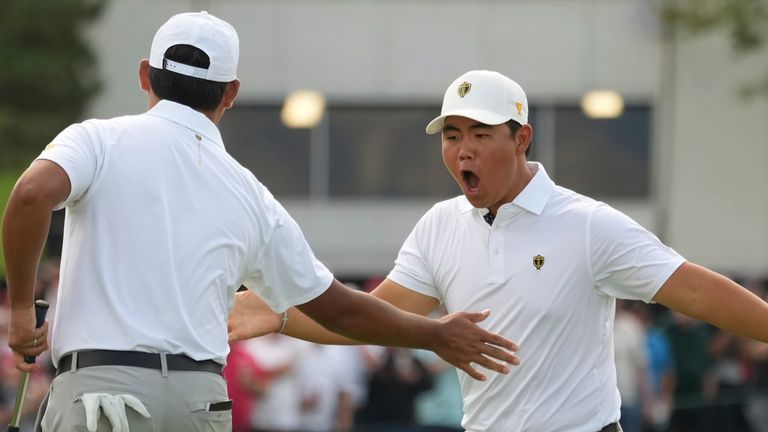 International team members Tom Kim, right, celebrates with partner Si Woo Kim, both of South Korea, after winning the 12th hole during the third round at the Presidents Cup golf tournament at Royal Montreal Golf Club in Montreal Saturday, Sept. 28, 2024. (Christinne Muschi/The Canadian Press via AP)