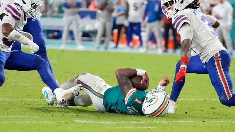 Miami Dolphins quarterback Tua Tagovailoa (1) falls to the field after colliding with Buffalo Bills safety Damar Hamlin (3) during the second half of an NFL football game, Thursday, Sept. 12, 2024, in Miami Gardens, Fla. (AP Photo/Rebecca Blackwell)