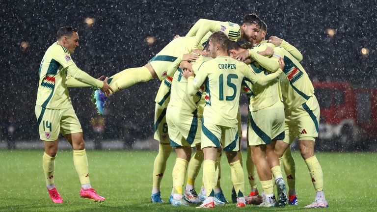 Wales celebrate going 2-0 up inside three minutes in a rainy Montenegro