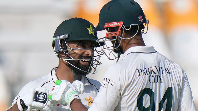 Pakistan's Abdullah Shafique, left, celebrates with teammate Shan Masood after scoring century during the first day of the first test cricket match between Pakistan and England, in Multan, Pakistan, Monday, Oct. 7, 2024. (AP Photo/Anjum Naveed)