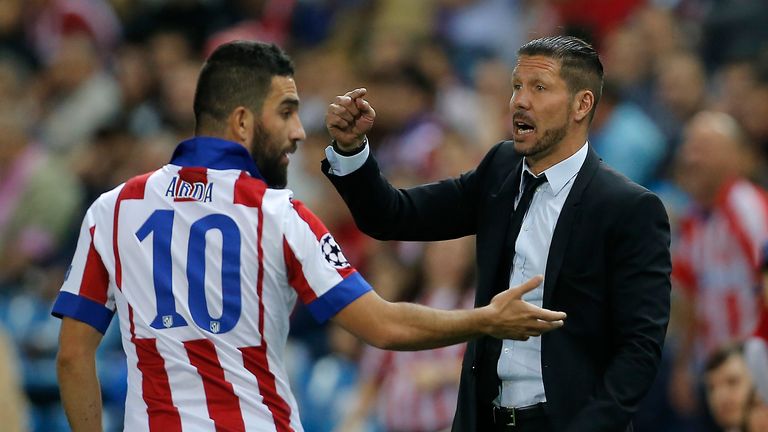 Atletico coach Diego Simeone, right, gives instructions as Atletico's Arda Turan gestures during the Group A Champions League soccer match between Atletico de Madrid and Malmo at the Vicente Calderon stadium in Madrid, Spain, Wednesday, Oct. 22, 2014