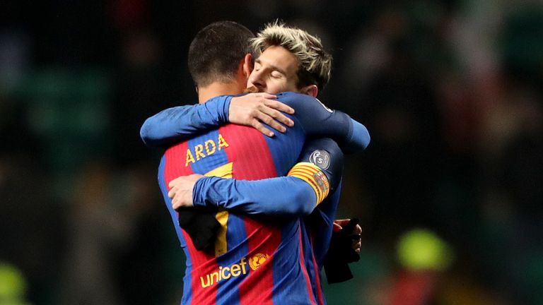 Barcelona's Lionel Messi (right) with team-mate Arda Turan (left) after the final whistle during the UEFA Champions League match at Celtic Park, Glasgow.