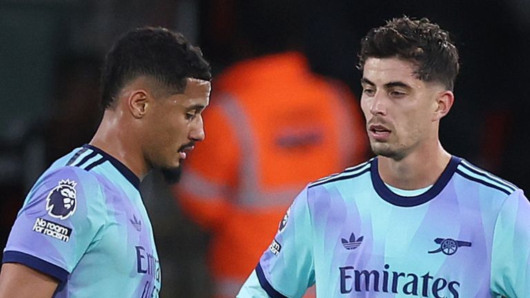 Arsenal's William Saliba (left) leaves the pitch after being shown a red card